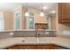 Spacious kitchen with a double sink and open view to the fireplace room at 322 Bellemont Rd, Pittsboro, NC 27312