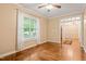 Bright living room with hardwood floors, large window, and ceiling fan for a cozy atmosphere at 322 Bellemont Rd, Pittsboro, NC 27312