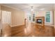 Large living room featuring a fireplace, many windows, and seamless flow into the kitchen at 322 Bellemont Rd, Pittsboro, NC 27312