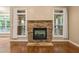 Cozy living room features a stone fireplace and natural light from windows at 322 Bellemont Rd, Pittsboro, NC 27312