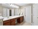 Bathroom offers a double vanity with storage, framed mirrors, and a tile floor at 406 Dairy Farm Dr, Hillsborough, NC 27278