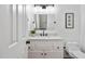 Renovated bathroom features a white vanity with marble top, black fixtures, and updated commode at 406 Dairy Farm Dr, Hillsborough, NC 27278
