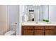 Well-lit bathroom features a modern vanity with granite countertop and a decorative mirror at 406 Dairy Farm Dr, Hillsborough, NC 27278