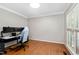 Bright bedroom features neutral walls, hardwood floors, white trim, and a window letting in natural light at 406 Dairy Farm Dr, Hillsborough, NC 27278