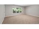 The spacious bedroom is painted in neutral tones, offering a large window and plush carpeting throughout at 406 Dairy Farm Dr, Hillsborough, NC 27278