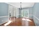 Traditional dining room featuring wainscoting, hardwood floors, and decorative lighting at 406 Dairy Farm Dr, Hillsborough, NC 27278