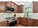 Well-lit kitchen featuring granite countertops, stainless steel appliances, and custom cabinetry at 406 Dairy Farm Dr, Hillsborough, NC 27278