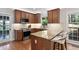 Open kitchen with granite countertops, stainless steel appliances, and a breakfast bar at 406 Dairy Farm Dr, Hillsborough, NC 27278