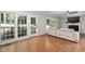 Living room with backyard access, hardwood floors, fireplace, and ceiling fan at 406 Dairy Farm Dr, Hillsborough, NC 27278