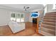 Bright living room features fireplace, tv, hardwood floors, and stairway at 406 Dairy Farm Dr, Hillsborough, NC 27278