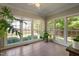 Bright sunroom featuring large windows with views of the landscaped backyard at 406 Dairy Farm Dr, Hillsborough, NC 27278