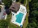 Aerial view of a community pool with lounge chairs, tables, and lush landscaping at 4536 Sugarbend Way, Raleigh, NC 27606