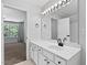 Bathroom with double vanity, large mirror, and tiled floors, creating a bright and functional space at 4536 Sugarbend Way, Raleigh, NC 27606