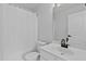 Bright bathroom features white fixtures, vanity with modern faucet, and shower with curtain at 4536 Sugarbend Way, Raleigh, NC 27606
