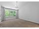 Spacious bedroom with large windows offering natural light, neutral walls, and neutral carpet at 4536 Sugarbend Way, Raleigh, NC 27606