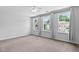 Spacious bedroom with three windows offering natural light, neutral walls, carpet, and a ceiling fan at 4536 Sugarbend Way, Raleigh, NC 27606