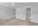Spacious bedroom with neutral carpet, ceiling fan, and large closet doors at 4536 Sugarbend Way, Raleigh, NC 27606