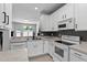 Bright kitchen features white cabinets, stainless steel appliances and light countertops at 4536 Sugarbend Way, Raleigh, NC 27606