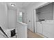 Upstairs laundry room area with white washer and dryer, and storage space at 4536 Sugarbend Way, Raleigh, NC 27606