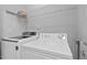 Laundry room features white washer and dryer with wire shelving at 4536 Sugarbend Way, Raleigh, NC 27606