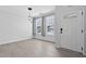 Bright, airy living room featuring wood floors, ample natural light, and modern lighting fixtures at 4536 Sugarbend Way, Raleigh, NC 27606