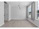 Bright, airy living room featuring wood floors, ample natural light, and modern lighting fixtures at 4536 Sugarbend Way, Raleigh, NC 27606