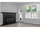 Cozy living room with a fireplace and large windows offering lots of natural light at 4536 Sugarbend Way, Raleigh, NC 27606