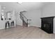 Open floorplan with living area featuring fireplace, stairs, and kitchen bar top at 4536 Sugarbend Way, Raleigh, NC 27606