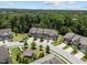 An aerial view of upscale townhomes nestled amidst a lush, wooded landscape at 469 Methven Grove Dr, Cary, NC 27519