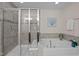 This bathroom features a soaking tub, a glass enclosed shower and a neutral color palette at 469 Methven Grove Dr, Cary, NC 27519