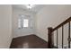 Bright foyer boasts dark hardwood floors and a staircase with a wooden railing at 469 Methven Grove Dr, Cary, NC 27519