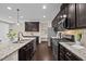 Stylish kitchen with dark cabinetry, stainless appliances, and granite countertops at 469 Methven Grove Dr, Cary, NC 27519