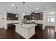 Spacious kitchen with a large island, dark cabinets, and stainless steel appliances at 469 Methven Grove Dr, Cary, NC 27519