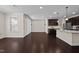 Open living area with hardwood floors, dark cabinetry, and granite countertops at 469 Methven Grove Dr, Cary, NC 27519