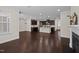 Open-concept living area featuring hardwood floors and a kitchen view at 469 Methven Grove Dr, Cary, NC 27519