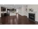 Spacious living room with hardwood floors, a fireplace, and an open kitchen at 469 Methven Grove Dr, Cary, NC 27519