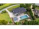 A luxurious home with a stunning pool, fire pit area, and meticulously landscaped grounds is shown from above at 4725 Saratoga Falls Ln, Raleigh, NC 27614