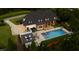 An outdoor living space includes a sparkling pool, pergola, and cozy fire pit, perfect for elegant entertaining at 4725 Saratoga Falls Ln, Raleigh, NC 27614