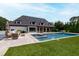 This backyard has an inground pool, lush greenery, and a covered pergola at 4725 Saratoga Falls Ln, Raleigh, NC 27614