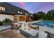 Outdoor living space offers an inground pool, spa and comfortable furniture for relaxing evenings at 4725 Saratoga Falls Ln, Raleigh, NC 27614