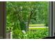 Picturesque view of the backyard featuring lush greenery, mature trees, and open space, providing a serene outdoor setting at 4725 Saratoga Falls Ln, Raleigh, NC 27614