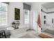 Bright bathroom featuring a freestanding soaking tub, custom cabinetry and a glass-enclosed shower for a spa-like experience at 4725 Saratoga Falls Ln, Raleigh, NC 27614