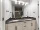Stylish bathroom features double vanity, granite countertop, and large mirror at 4725 Saratoga Falls Ln, Raleigh, NC 27614
