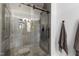 Modern bathroom featuring a glass-enclosed shower and sleek gray tile at 4725 Saratoga Falls Ln, Raleigh, NC 27614