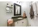 Bathroom featuring vanity with stylish mirror and shelves, providing functionality and style at 4725 Saratoga Falls Ln, Raleigh, NC 27614