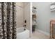 Bathroom offering a shower/tub combo and adjacent shelving space with plenty of storage at 4725 Saratoga Falls Ln, Raleigh, NC 27614