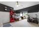 Modern bedroom with dark accent wall, wooden flooring, study desk, and a cozy chair at 4725 Saratoga Falls Ln, Raleigh, NC 27614