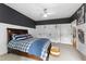 Spacious bedroom featuring dark accent wall and plenty of natural light at 4725 Saratoga Falls Ln, Raleigh, NC 27614