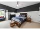 Bright bedroom with stylish dark accent wall, a ceiling fan, and a large bed at 4725 Saratoga Falls Ln, Raleigh, NC 27614