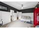 Bedroom featuring white trim, contrasting paint color, a couch, and hallway access at 4725 Saratoga Falls Ln, Raleigh, NC 27614